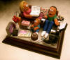 Mom, Dad and videogaming Junior portrayed in this clay caricature!