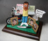 Dad's 50th Birthday clay caricature, with his mtn. bike, family photos,destination post and handy machete 