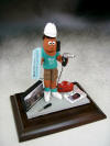Contractor figurine including blueprints and picture of the home he was working on