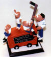  hockey coach figurine riding on a zambione machine with some of the team