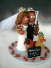 in this Cake Topper the hunting Groom and Bride are shown with their trusty lab, holding a skeet disc in his mouth